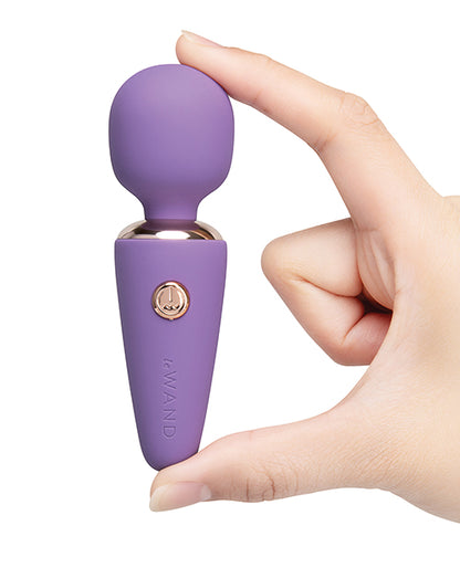 Hand holding the Le Wand Mini Micro Wand violet to show compact size
