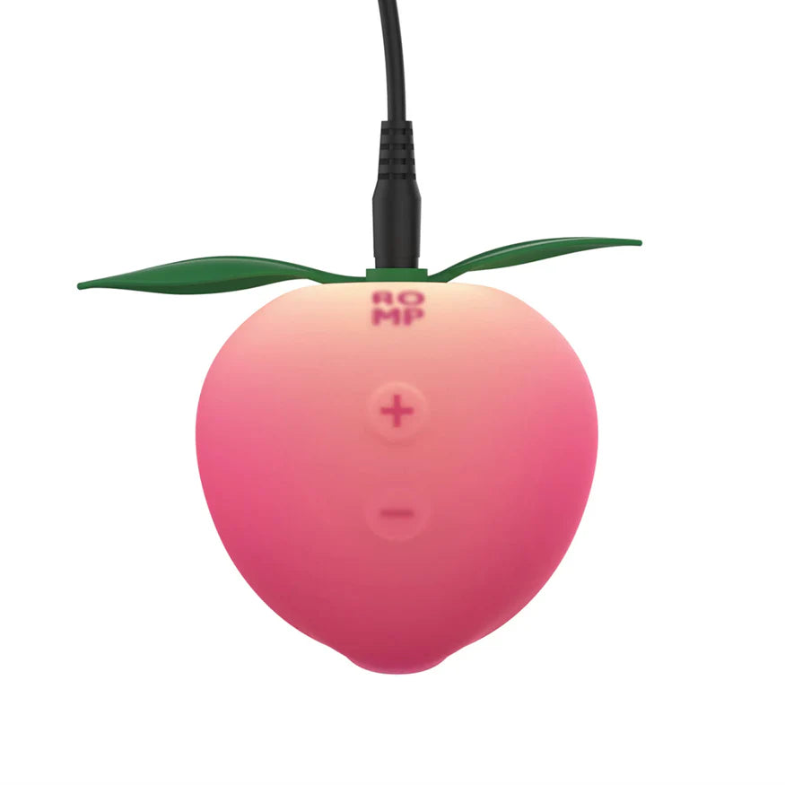 ROMP Pink Peach Pleasure Air Technology clitoral stimulator in pink peach — 14 intensities, IPX7 waterproof, rechargeable, body-safe silicone — comes with display stand
